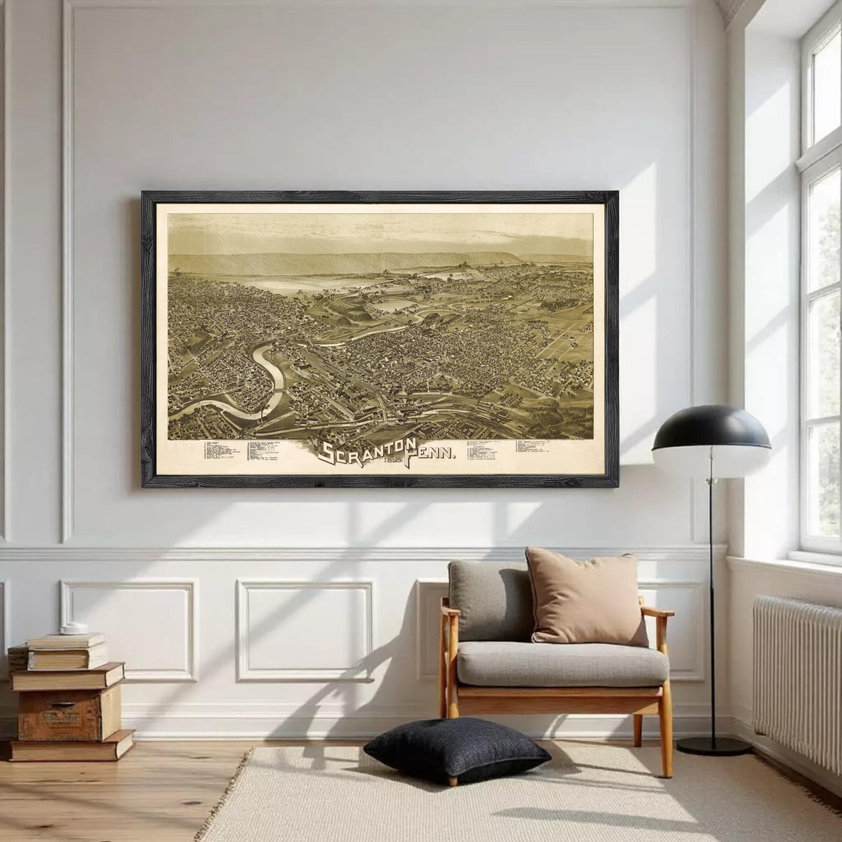 a large framed map of a city hanging on a white wall in a living room.