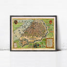 The image is a framed vintage map of a city, depicting a detailed layout of the streets, buildings, and surrounding landscape.