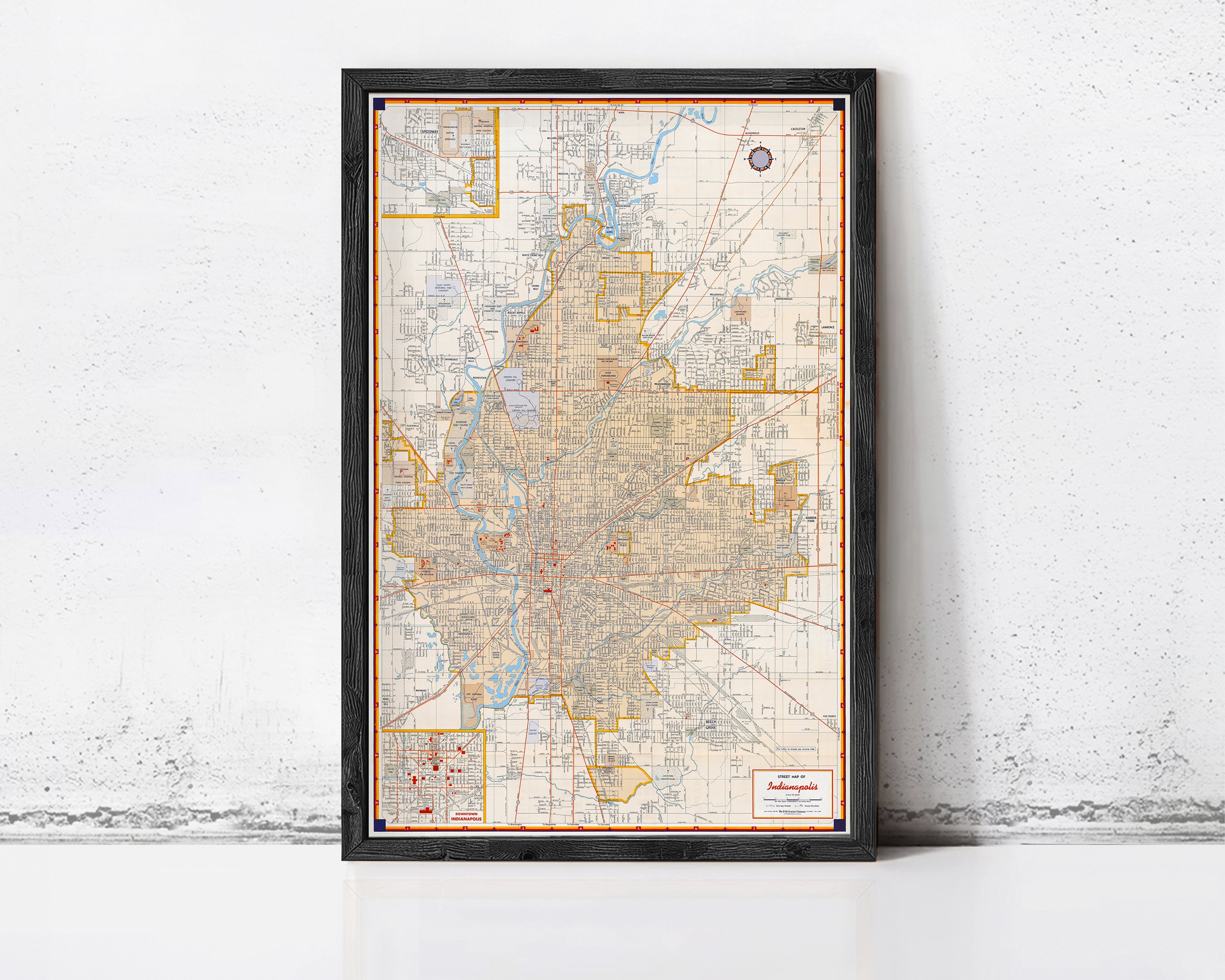 The image is a framed map of a city, likely showing the layout of streets, neighborhoods, and other geographic features.