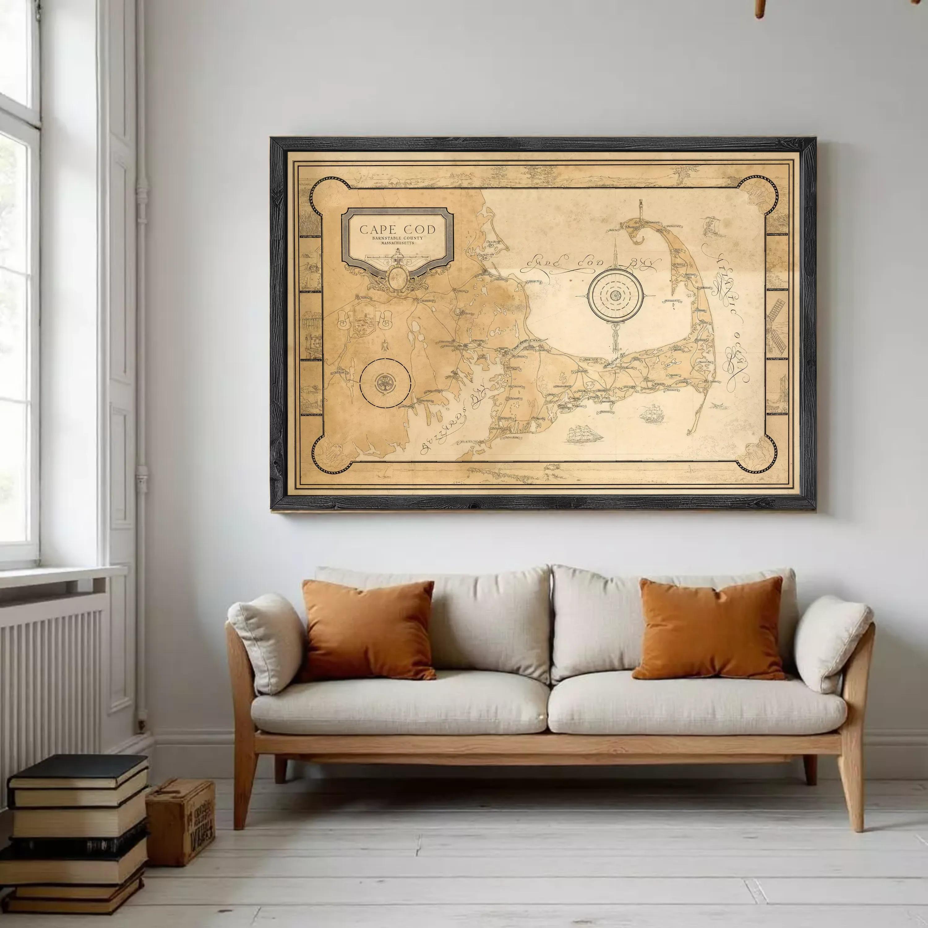a large framed map of Cape Cod, a coastal region in Massachusetts, Massachusetts, USA, hanging on a wall above a white sofa with orange throw pillows.