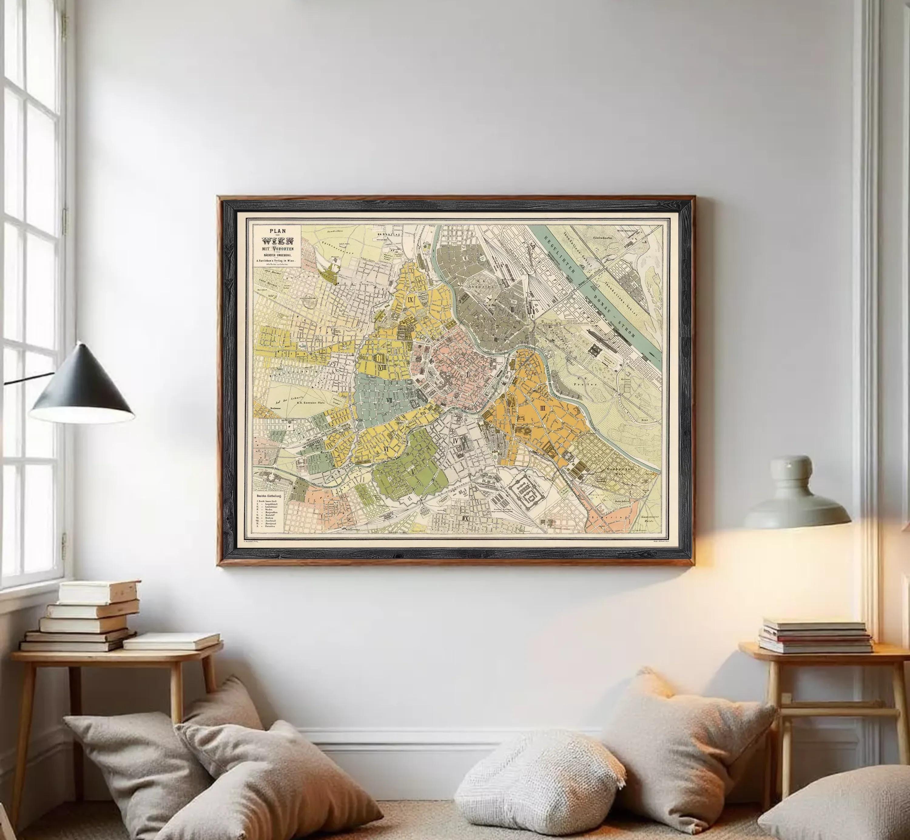 The image is a framed vintage map of a city, likely from the 19th century, displayed on a wall.