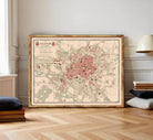 The image is a framed vintage map of a city, likely from the 19th century, with a detailed layout of streets, buildings, and other urban features.