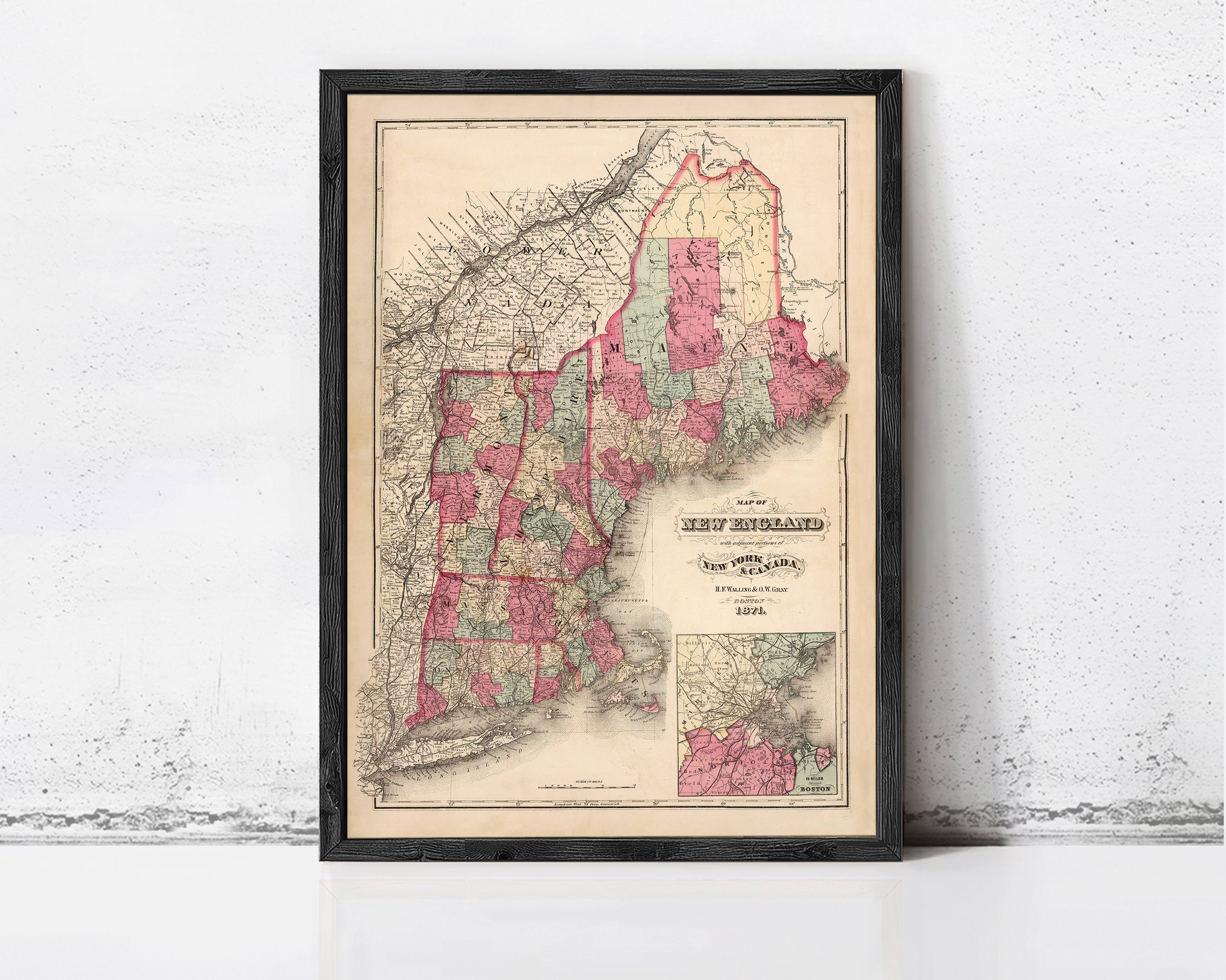 The image is a framed vintage map of New England, depicting the region in a detailed and colorful manner.