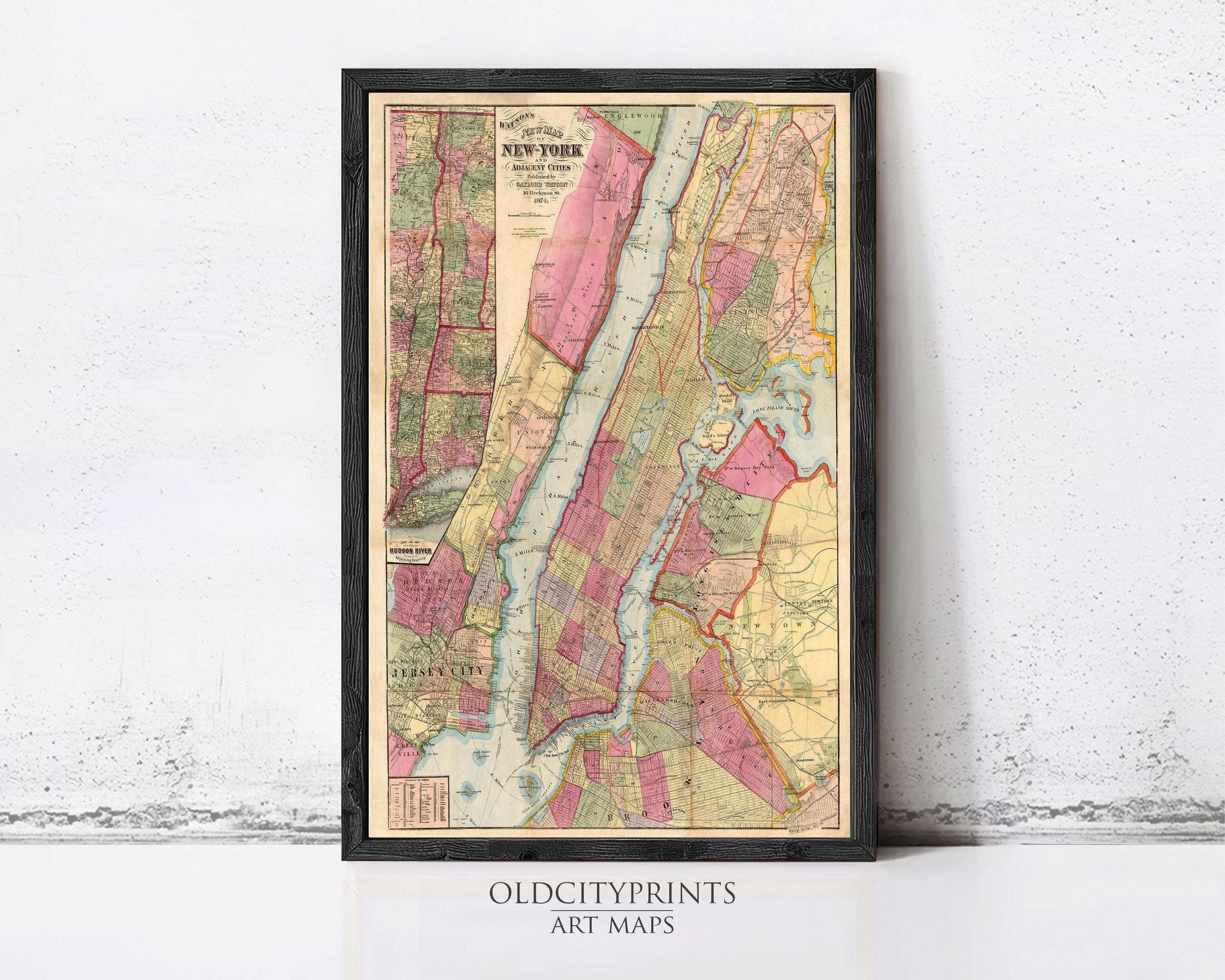 The image is a framed vintage map of New York City, depicting the city's streets, neighborhoods, and surrounding areas.