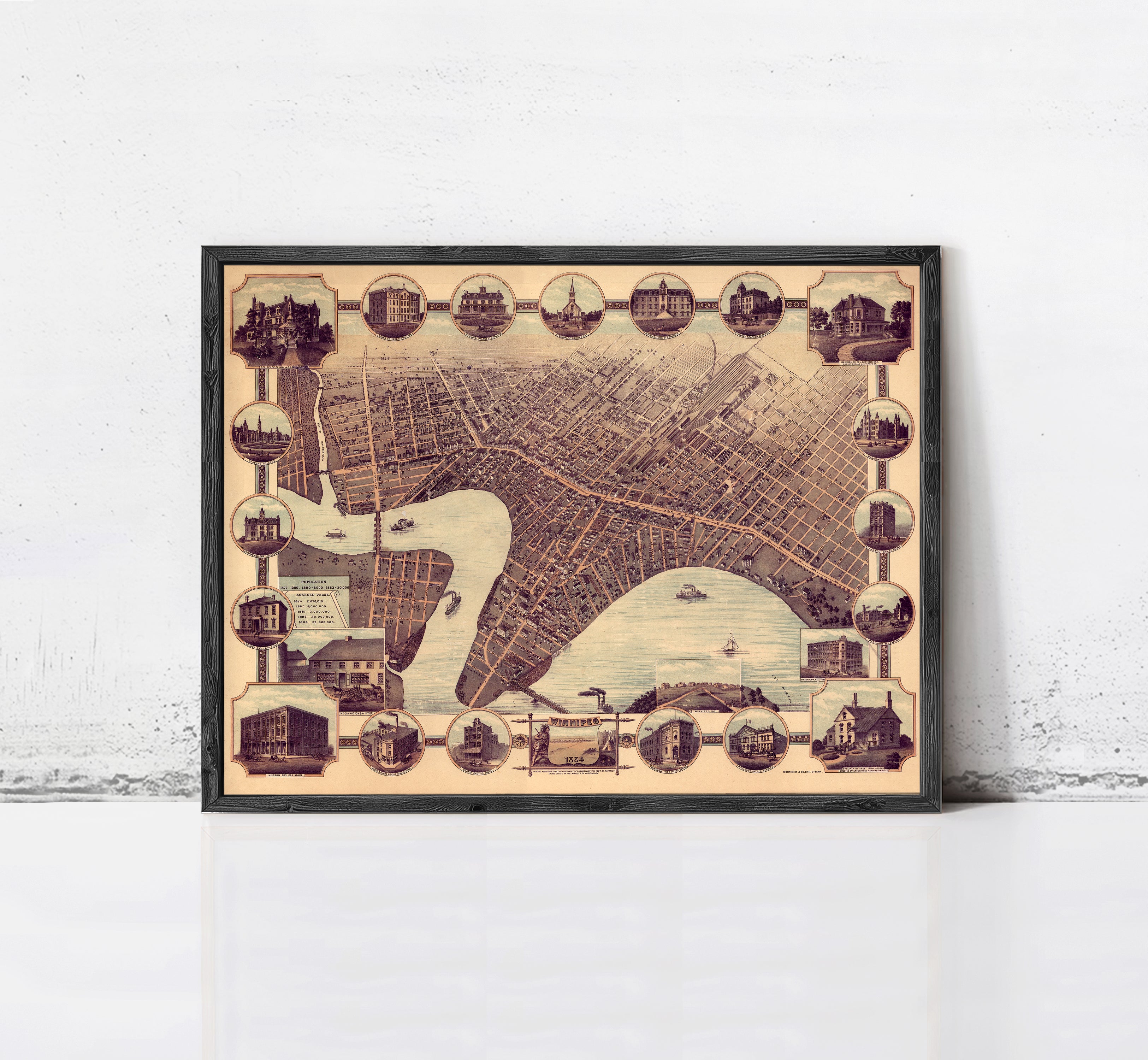 The image is a framed vintage map of a city, featuring various landmarks and buildings depicted in a collage-like arrangement.