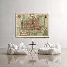 a large, colorful map of a city displayed on the wall above two white bean bag chairs and a small black table.