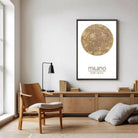 a modern living room with a wooden chair, a wooden desk, and a framed poster of a map of Milan hanging on the wall.