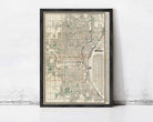 The image is a framed map of a city, likely Chicago, Illinois, with a detailed layout of streets, landmarks, and other geographic features.
