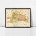The image is a framed vintage map of a city, likely from the 19th century, depicting the layout and streets of the area.