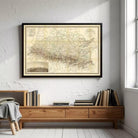 a framed map of South America hanging on a white wall above a wooden bookshelf filled with books.