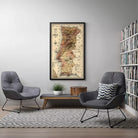 a cozy living room with a large framed map of Portugal hanging on the wall. The room is furnished with two gray armchairs and a wooden coffee table, creating a comfortable and inviting atmosphere.
