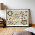 The image is a framed vintage map of the island of Cyprus, depicting the country's geographical layout and surrounding areas.