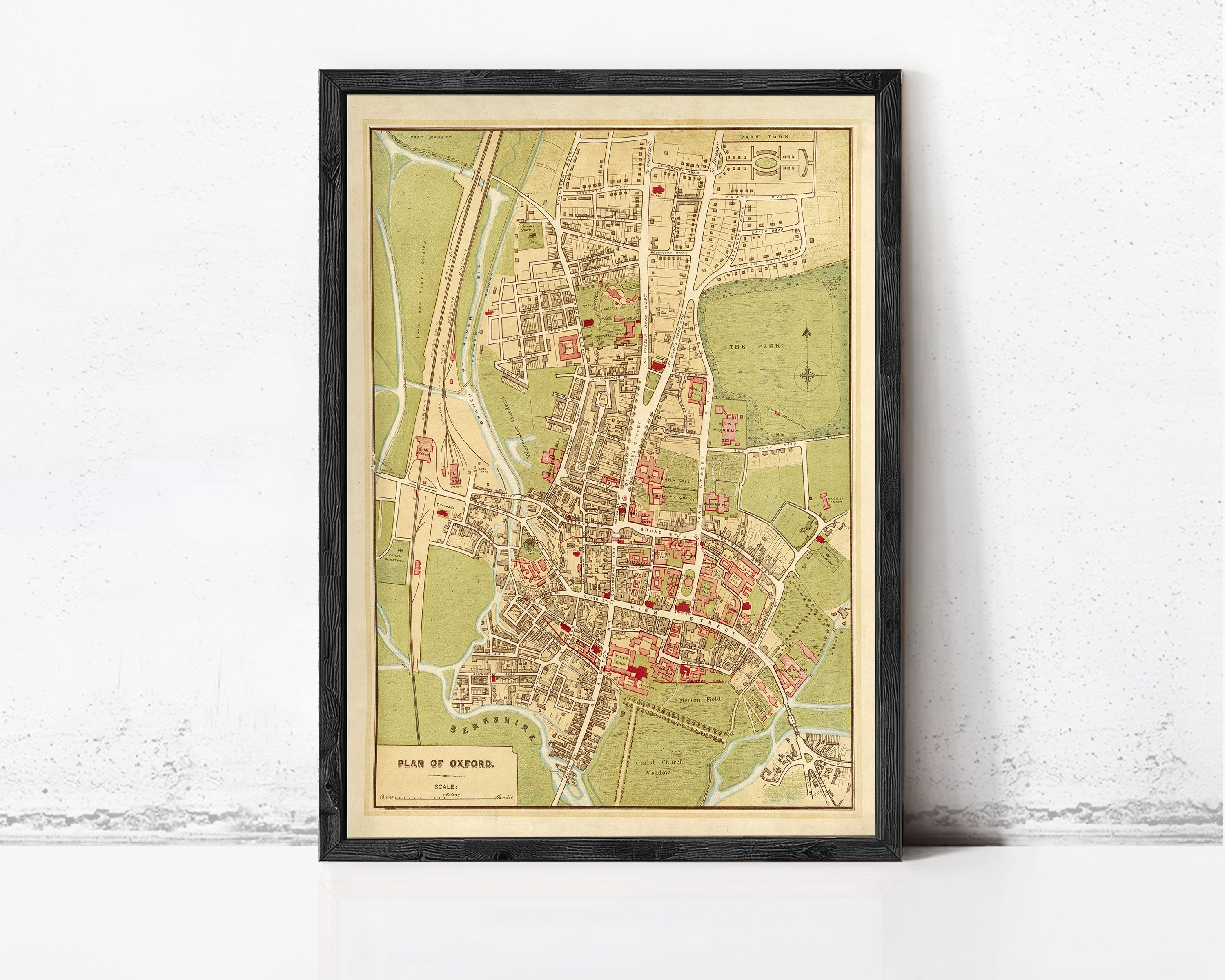 The image is a framed vintage map of Oxford, England, depicting the city's layout and surrounding areas.