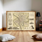 The image is a framed vintage map of a city, featuring various architectural landmarks and buildings.