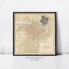 The image is a framed vintage map of a city, likely from the early 20th century, with detailed street and neighborhood maps.
