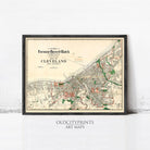 The image is a framed vintage map of Cleveland, Ohio, depicting the city's streets and surrounding areas.