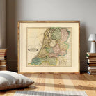 The image is a framed map of the Netherlands, depicting the country's geographical layout and boundaries.