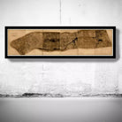 A framed map of a city or region is hanging on a wall.