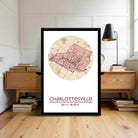 A framed map of Charlotteville, North Carolina, with a lamp and bookshelf in the background.