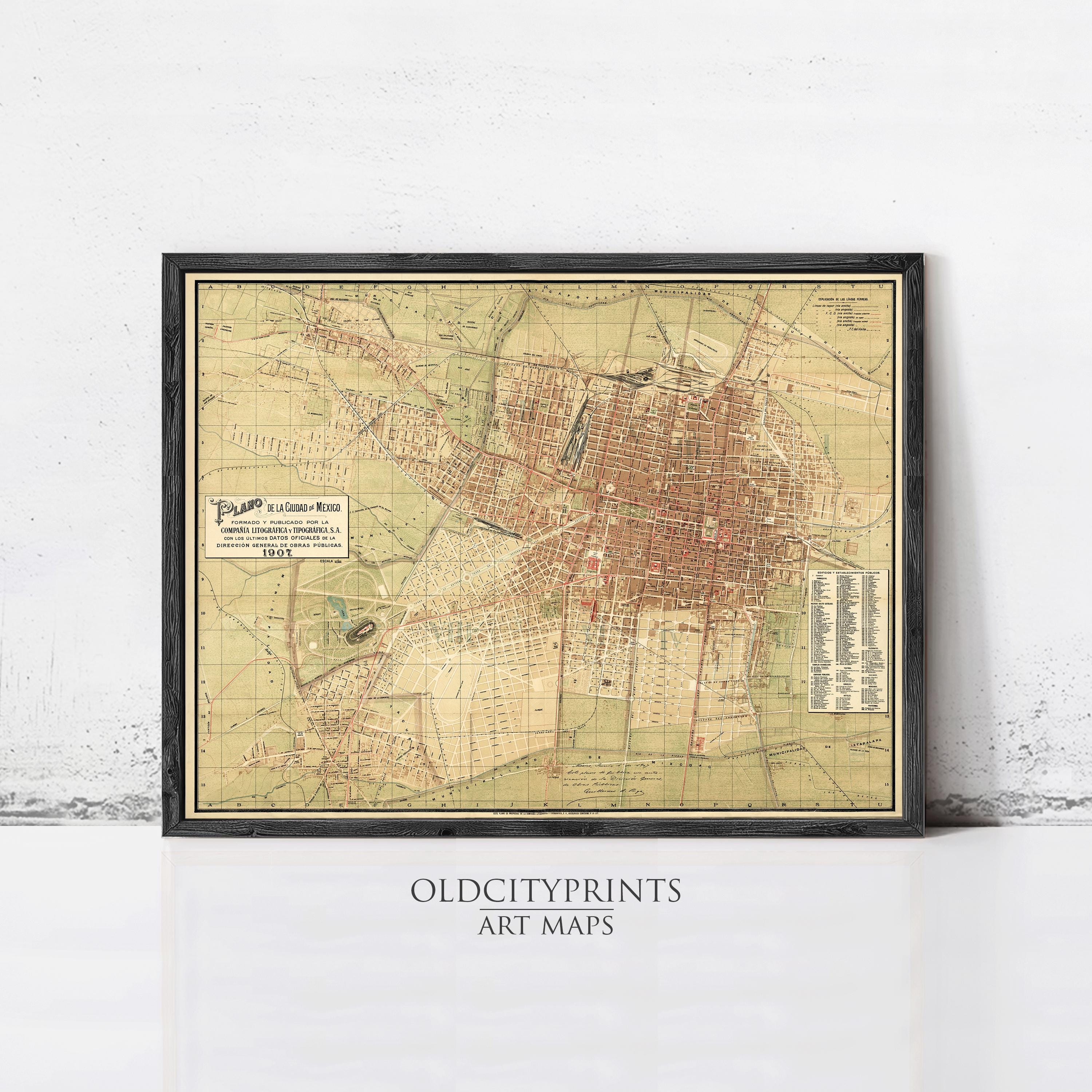 The image is a framed vintage map of a city, likely from the early 20th century, displayed on a wall.
