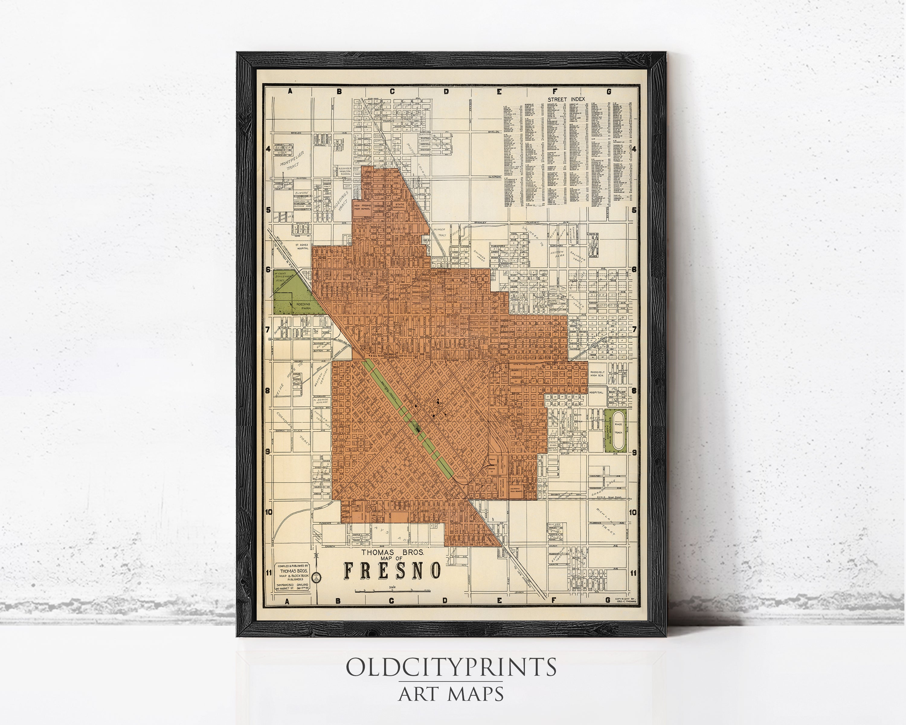 The image is a framed vintage map of the city of Fresno, California, with a black border and a beige background.
