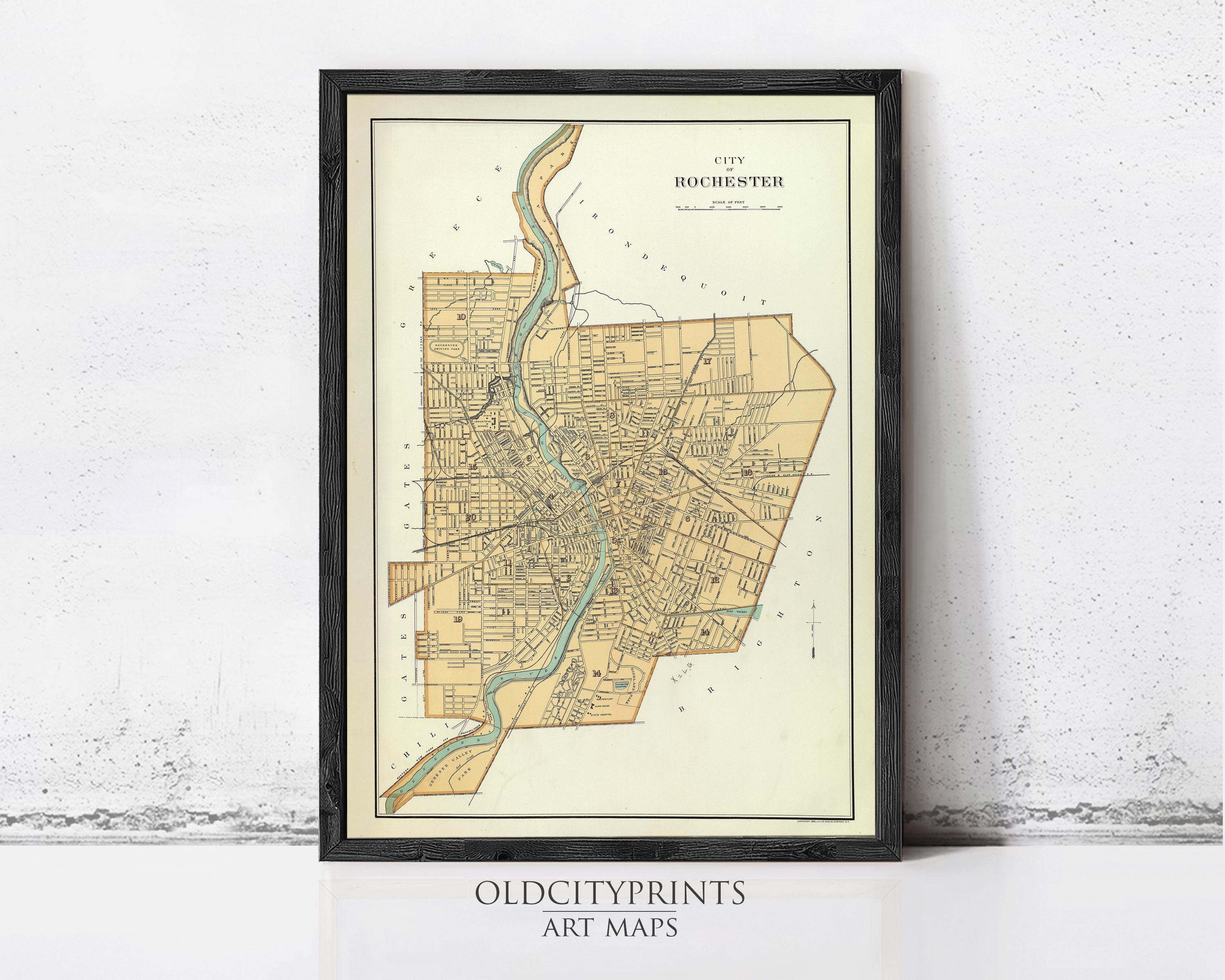 The image is a framed vintage map of the city of Rochester, New York, depicting the city's streets and surrounding areas.