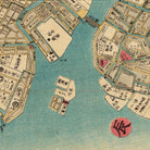 The image is a detailed map of a city, likely in Japan, with various streets, buildings, and landmarks depicted. The map includes a large body of water and a bridge, as well as numerous labels and markings in Japanese. The image is not a single photograph but rather a collage of multiple images, which suggests that it is a historical or vintage map.