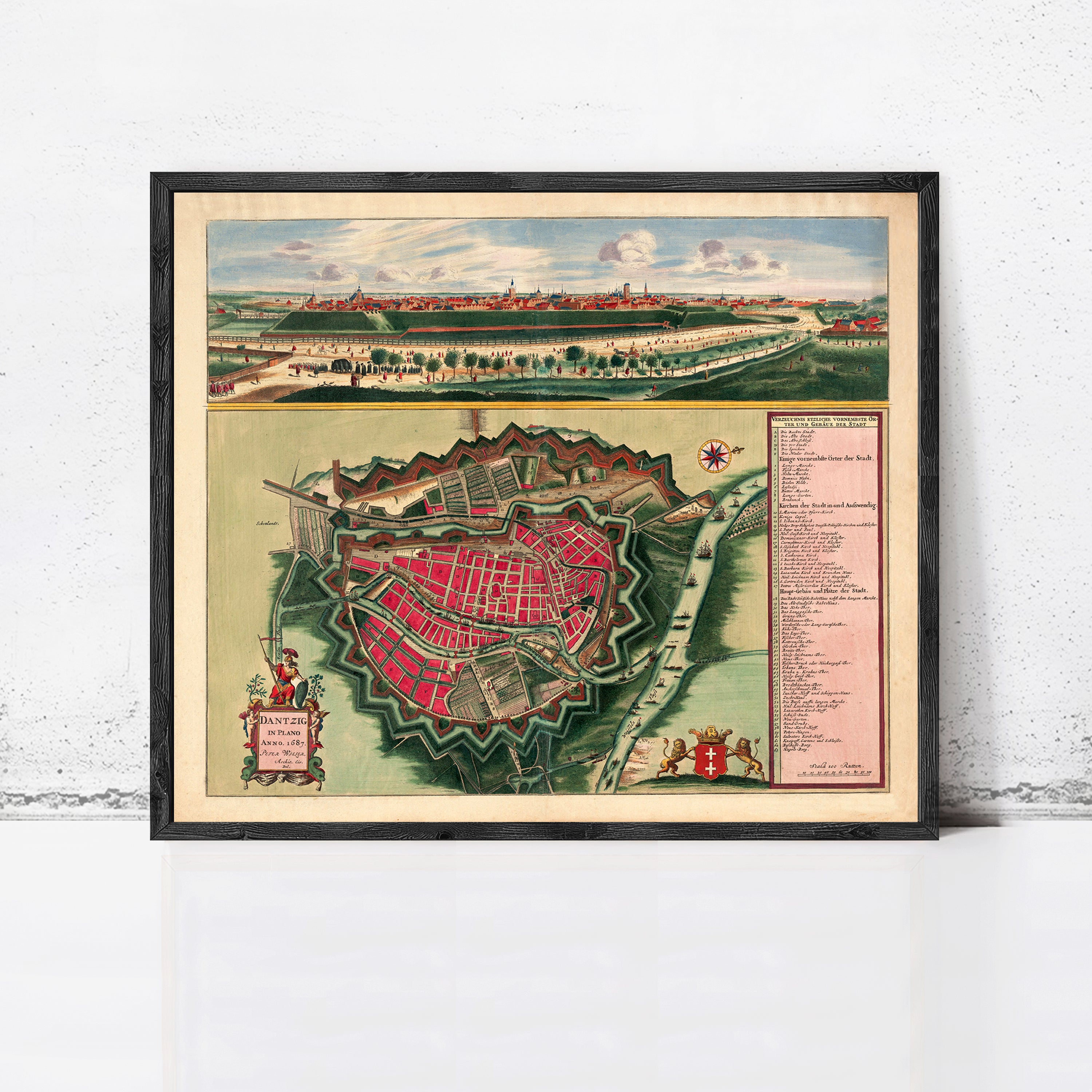 The image is a framed vintage map of a city, depicting a detailed layout of the city's streets, buildings, and surrounding landscape.