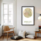 A framed map of Jersey City, New Jersey, with the city's location and compass directions printed on it.