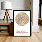A framed map of Minneapolis, Minnesota, with the city's location and coordinates displayed.