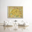 a large, colorful map of a region hanging on a white wall, with two white bean bag chairs positioned in front of it.