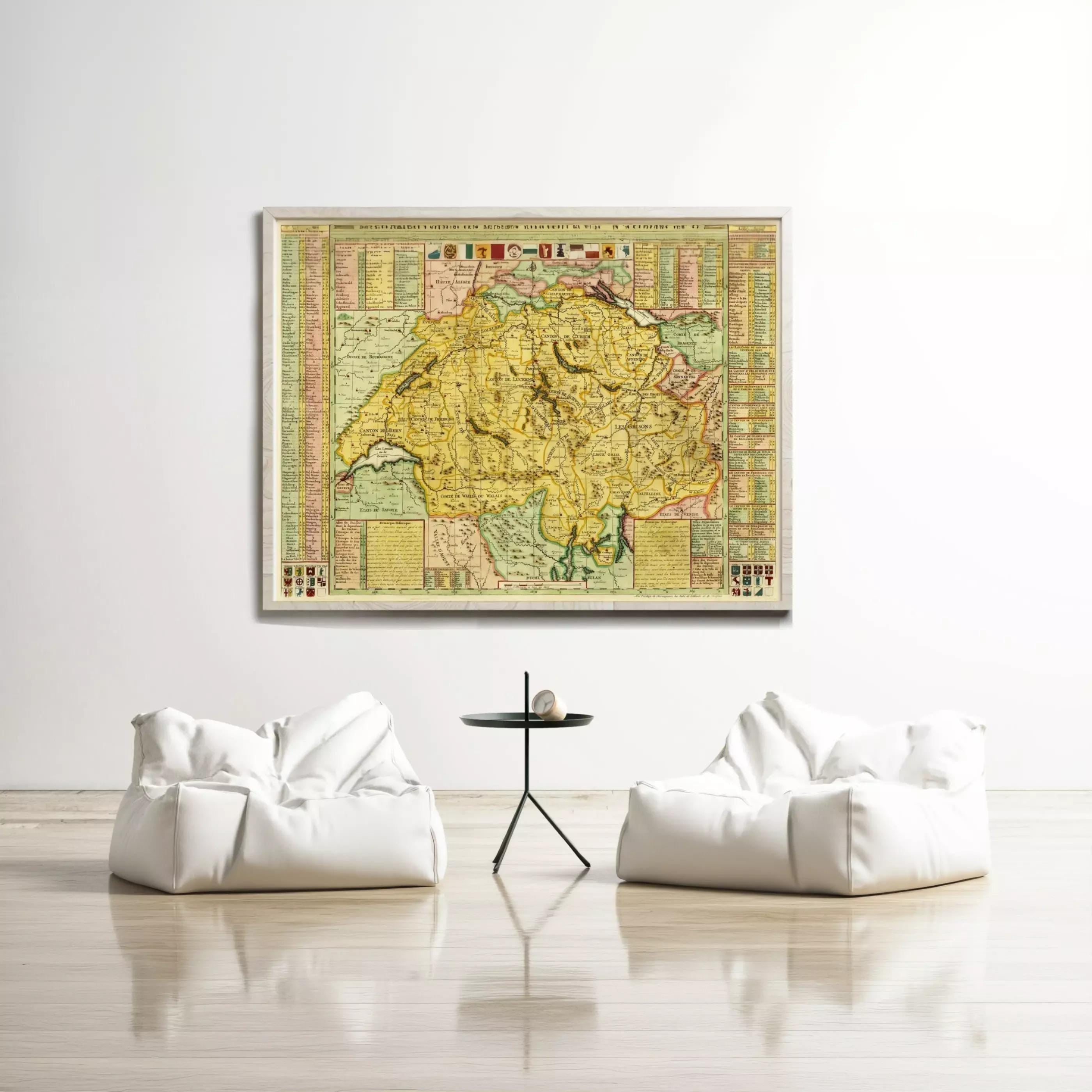 a large, colorful map of a region hanging on a white wall, with two white bean bag chairs positioned in front of it.