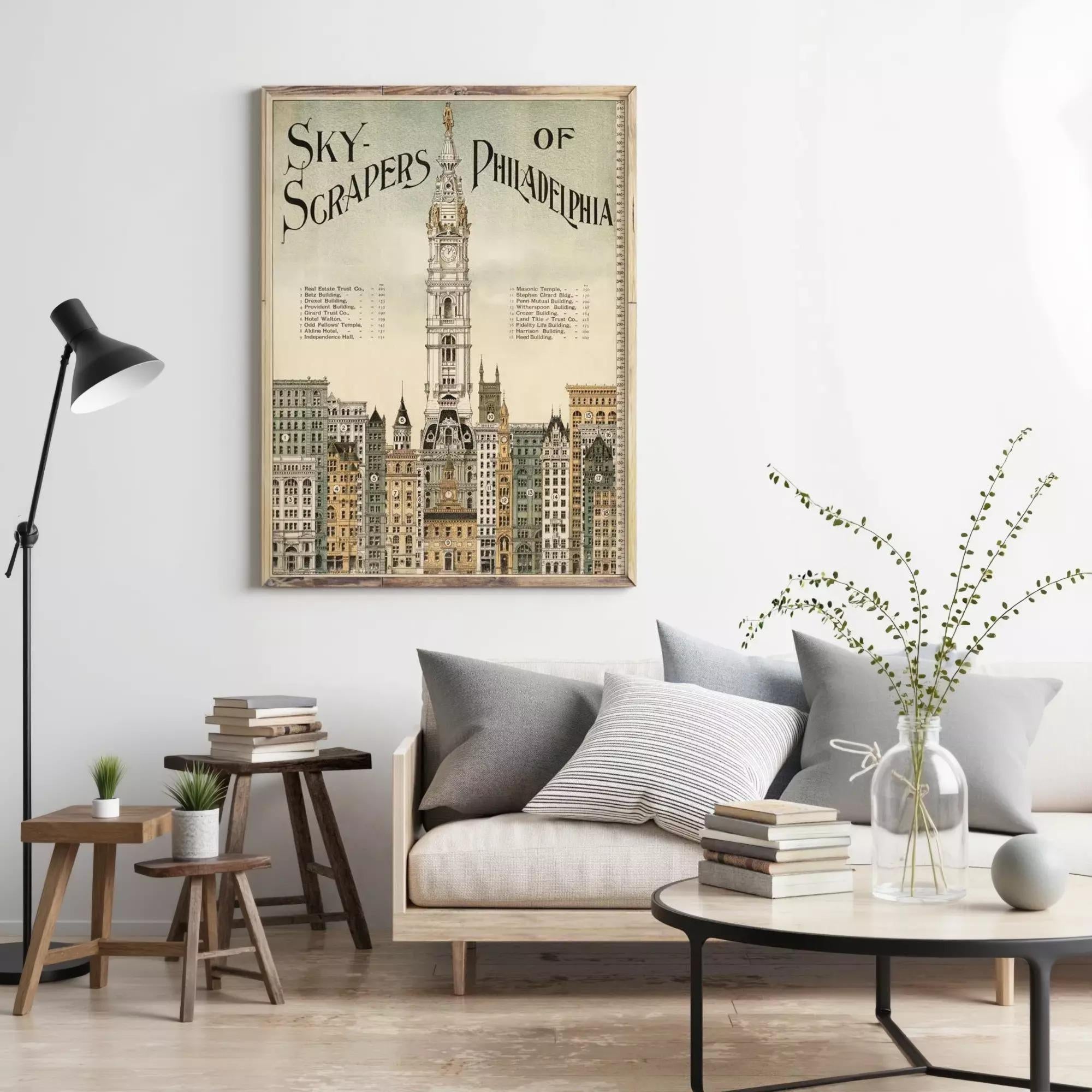 a poster of the Philadelphia skyline hanging on a wall, with a cozy living room setting below it.