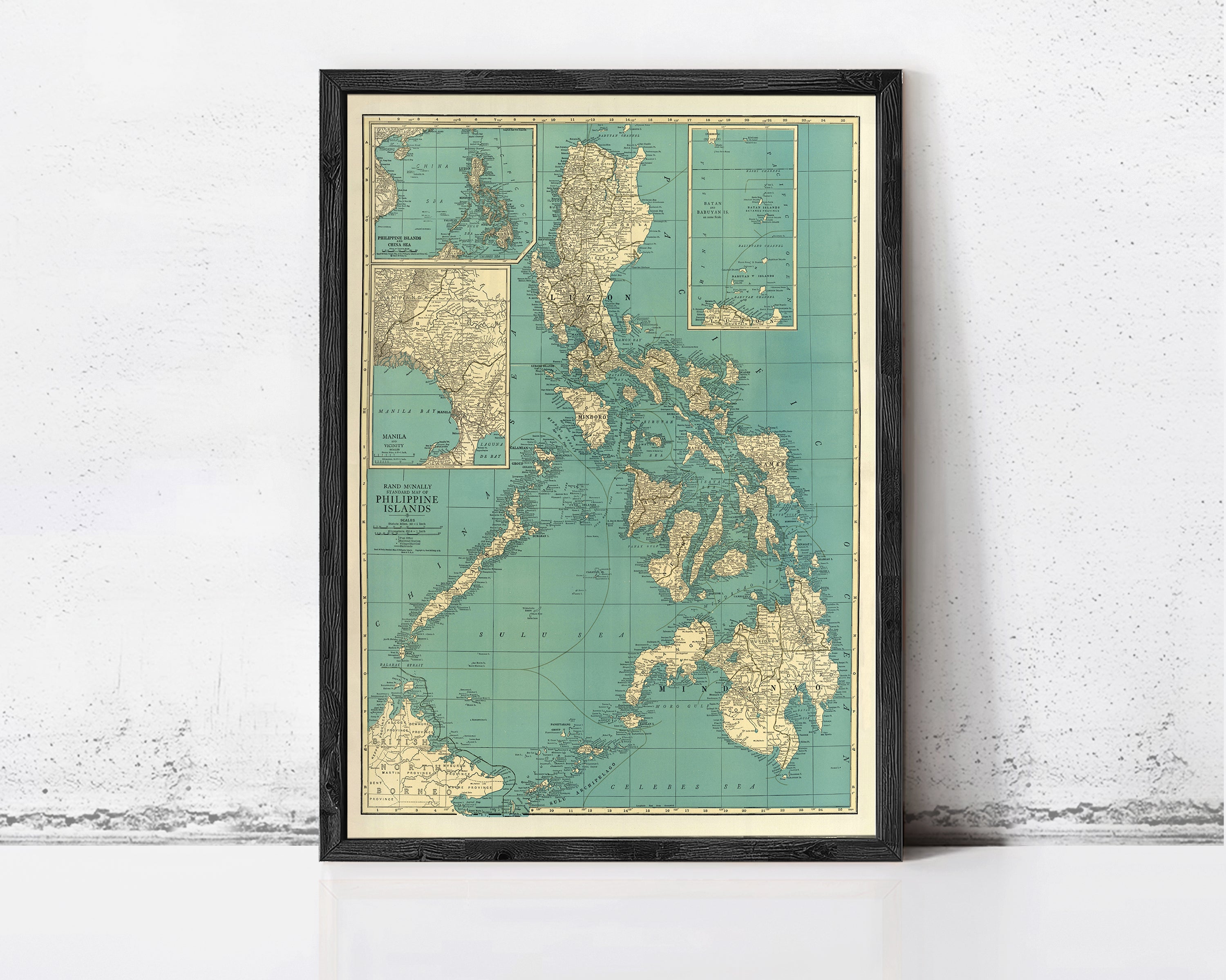 The image is a framed vintage map of the Philippines, showing the country's geographical layout and surrounding areas.