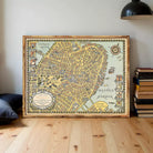 A framed vintage map of Boston, Massachusetts, depicting the city's streets and surrounding areas.