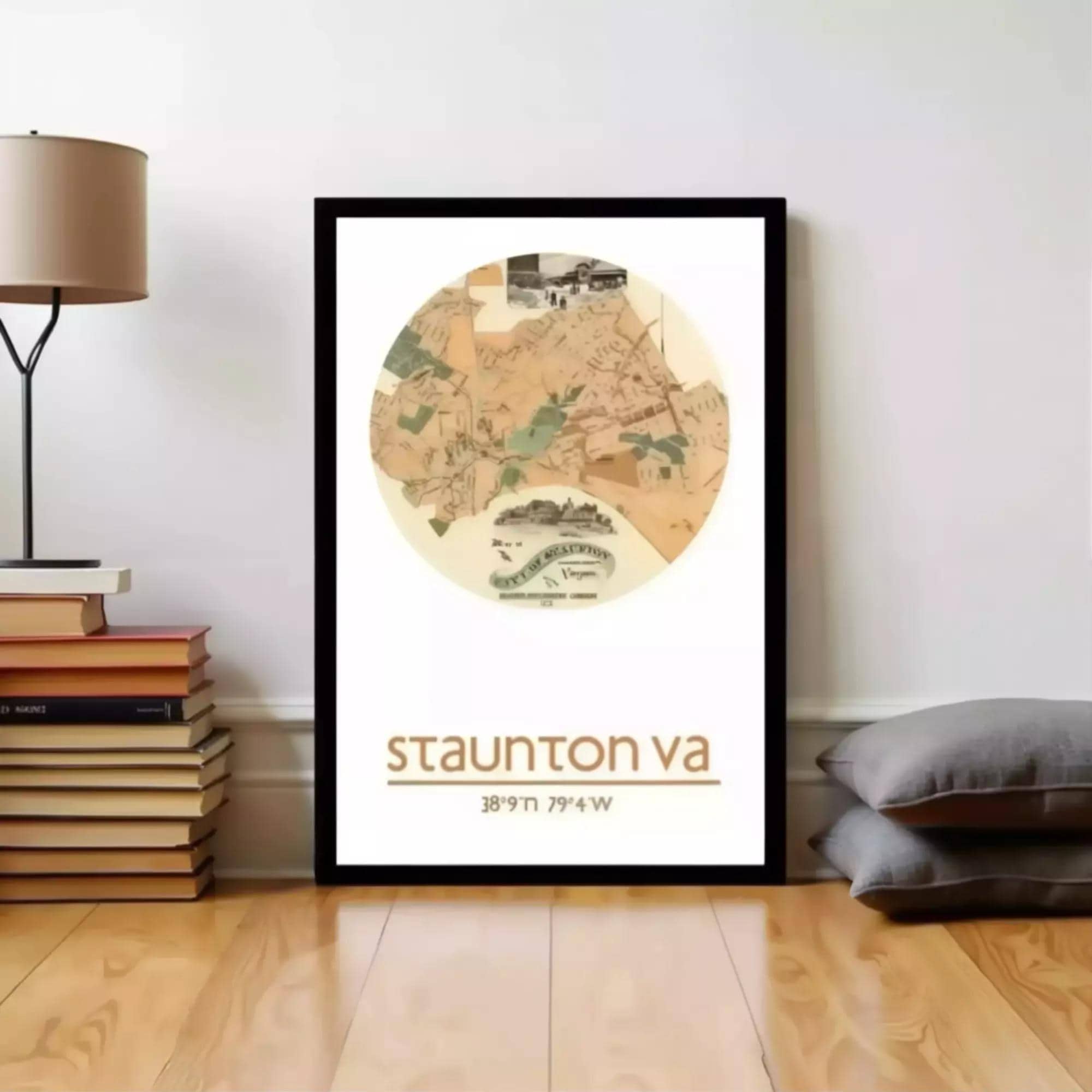 A framed map of Staunton, Virginia, with the text "Staunton VA 3897-79 W" printed on it, is displayed on a wall next to a stack of books and a lamp.