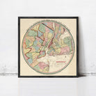 A framed vintage map of New York City, depicting the city's geographical layout and surrounding areas.