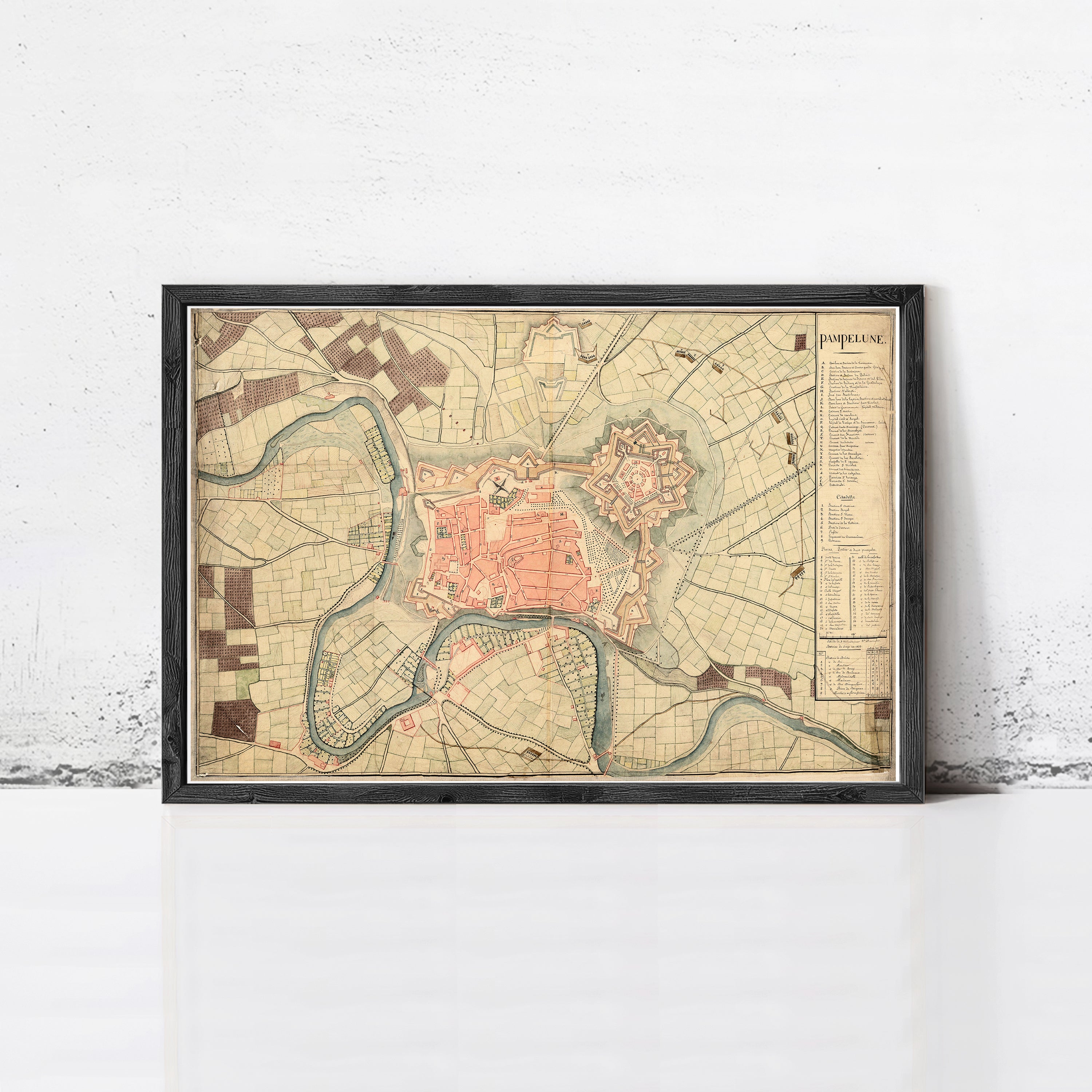 The image is a framed historical map of the city of Pampole, showing the layout of the city and surrounding areas.