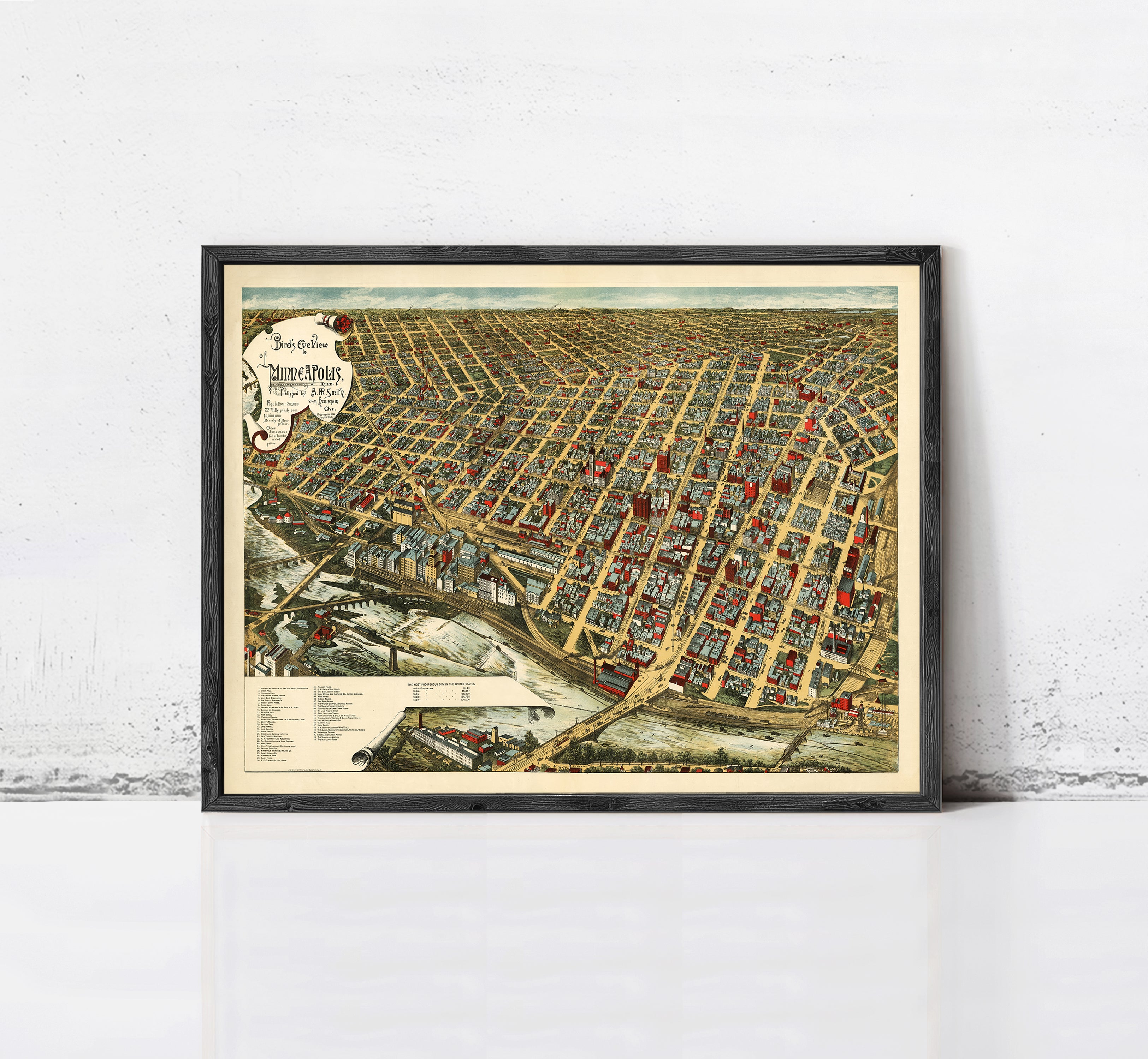 The image is a framed vintage map of a city, depicting a densely populated urban area with numerous buildings and streets.
