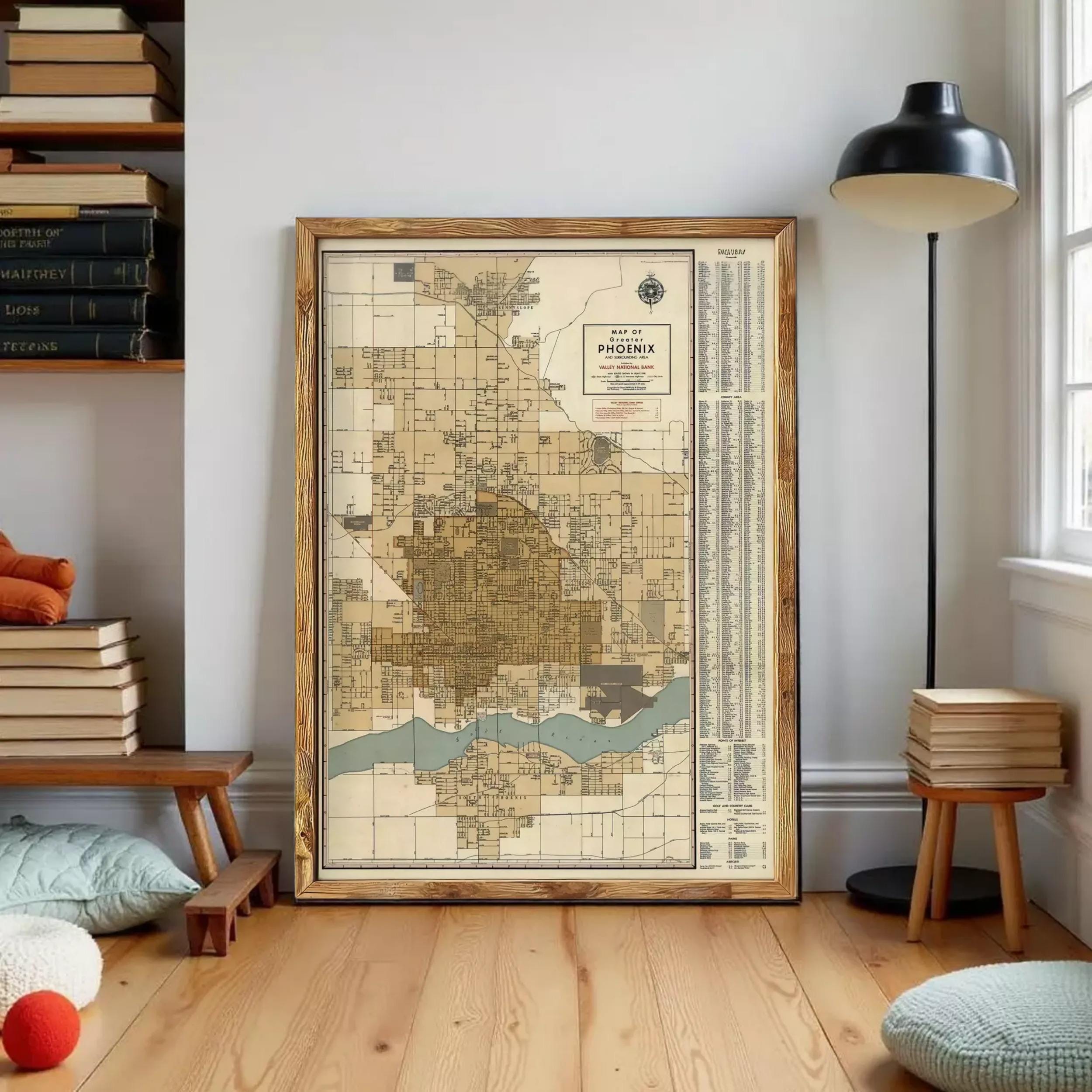 a large framed map of Phoenix, Arizona, with a wooden frame and a black lamp on a side table.