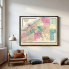 The image is a framed vintage map of Cleveland, Ohio, depicting the city's streets and neighborhoods in a colorful, detailed manner.