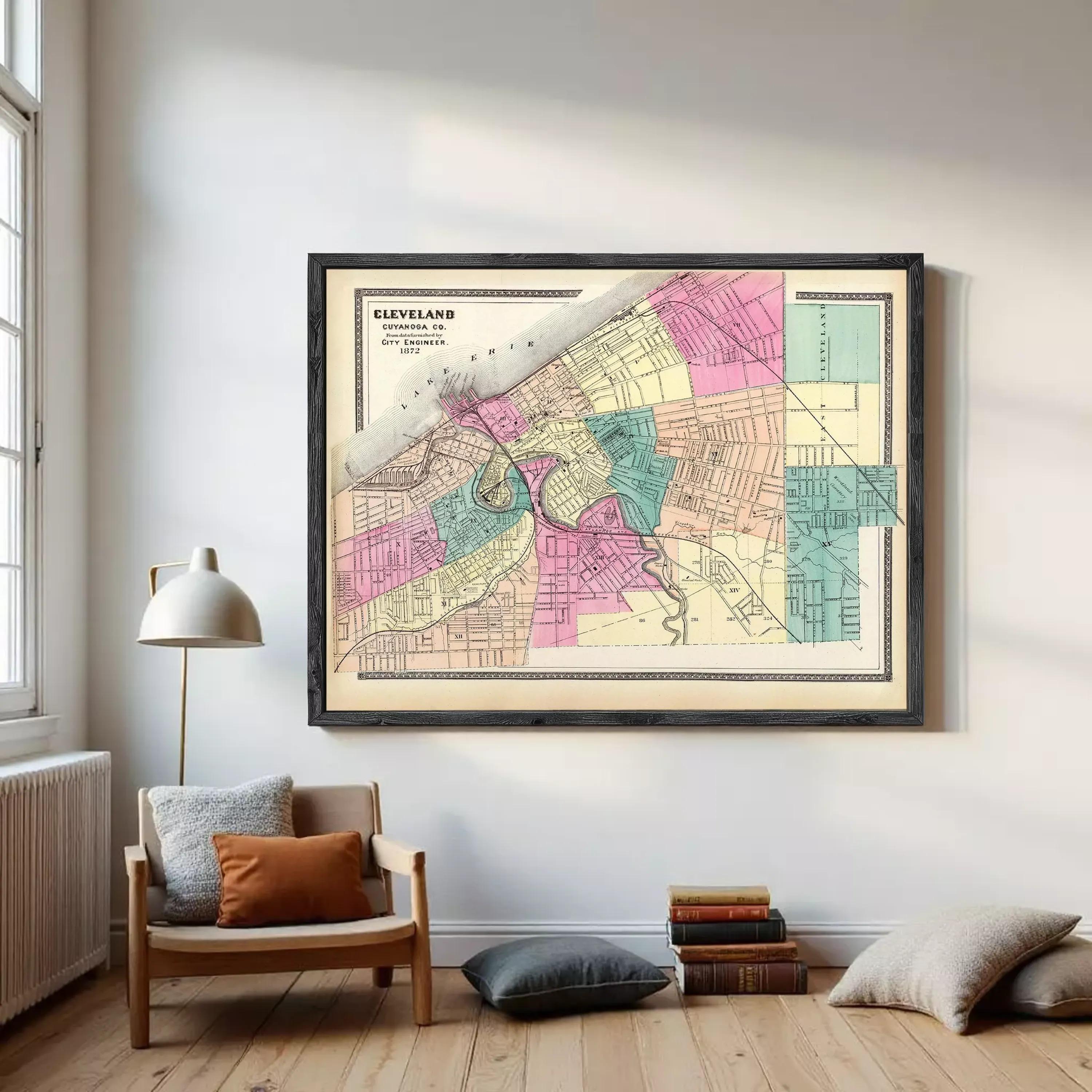 The image is a framed vintage map of Cleveland, Ohio, depicting the city's streets and neighborhoods in a colorful, detailed manner.