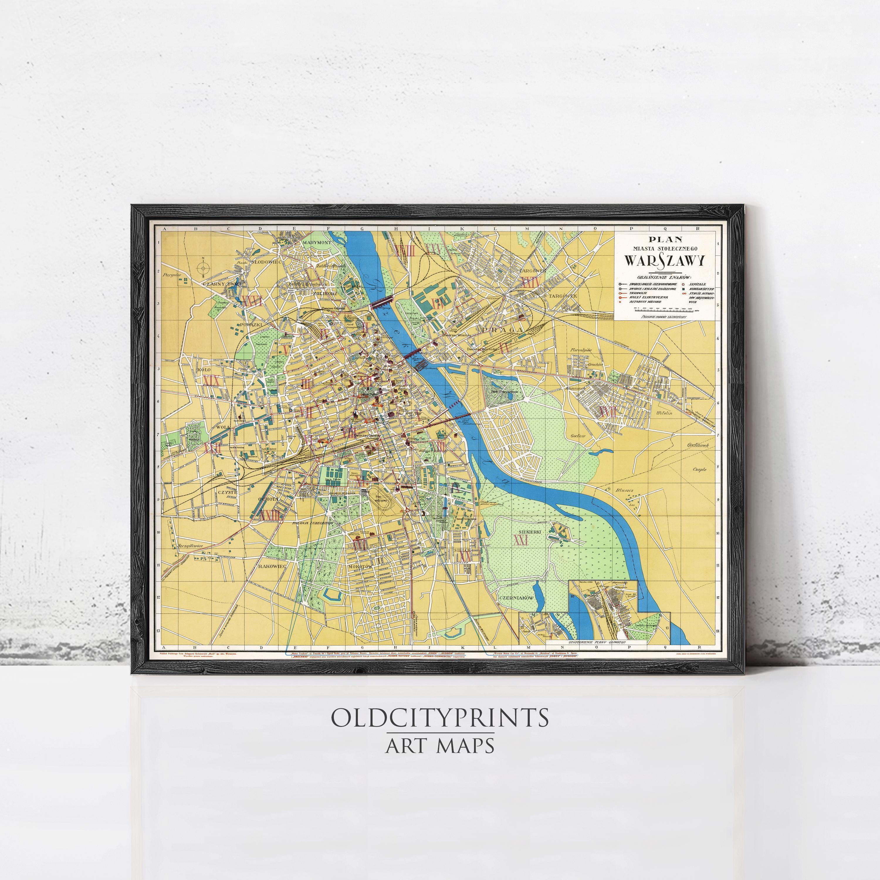 The image is a framed art map of Warsaw, Poland, depicting the city's streets, landmarks, and other geographical features.