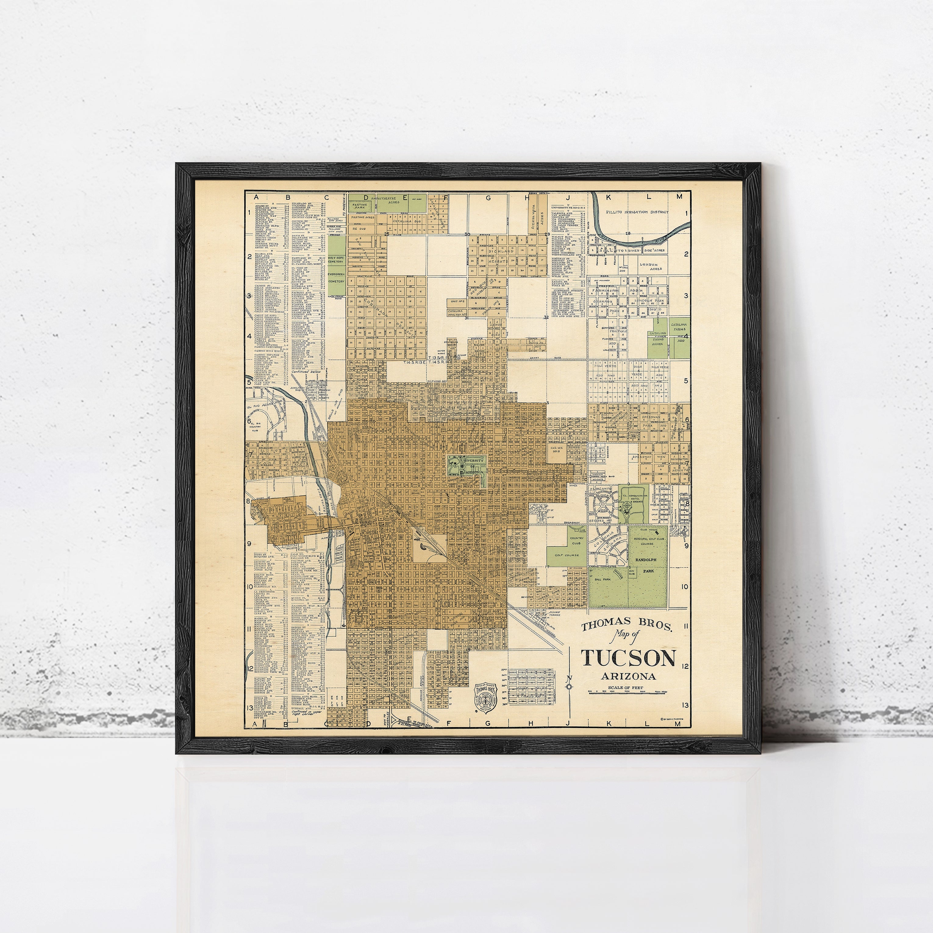 The image is a framed vintage map of Tucson, Arizona, depicting the city's layout and surrounding areas.