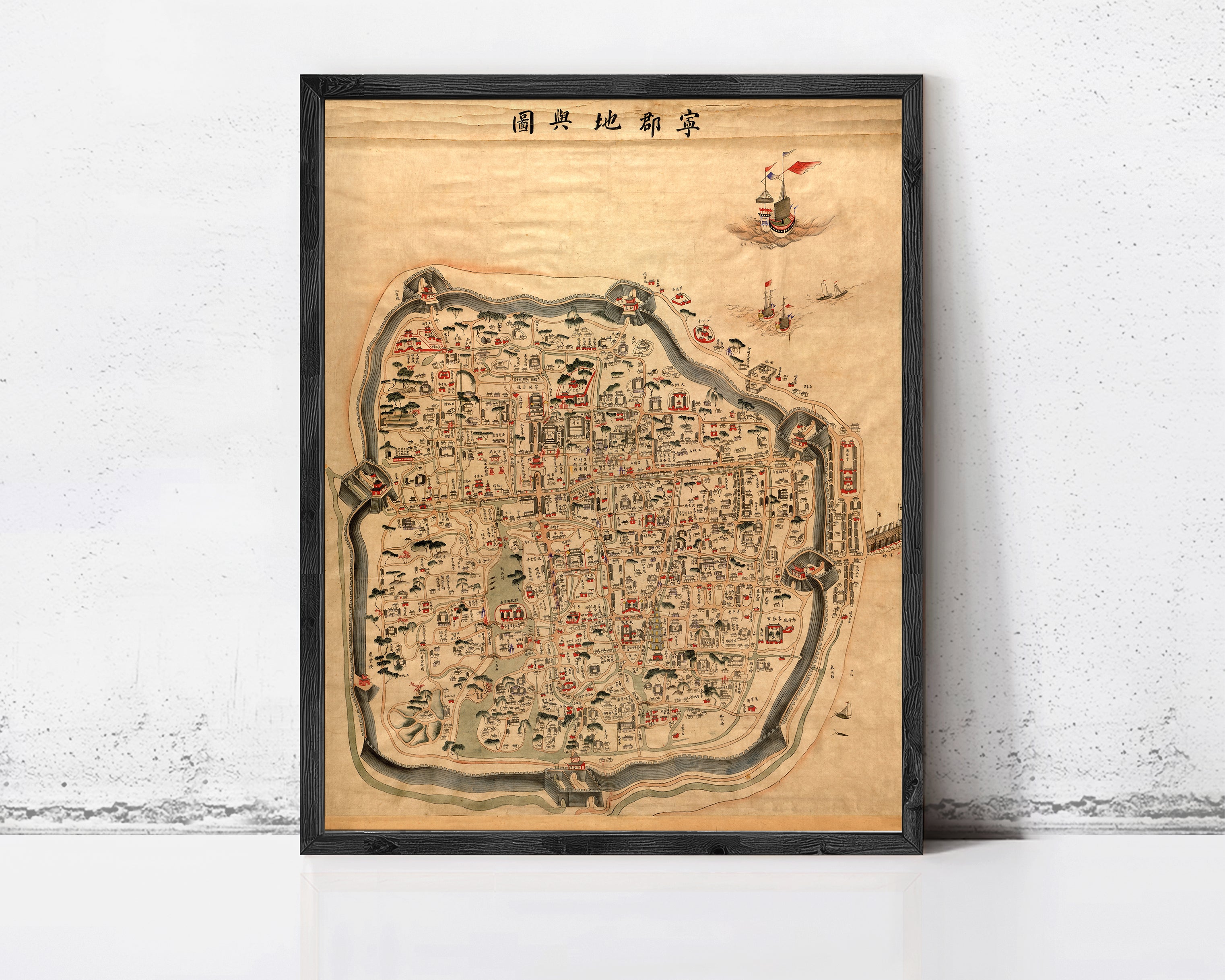The image is a framed map of a city, likely from an ancient or historical period, with various landmarks and streets depicted.