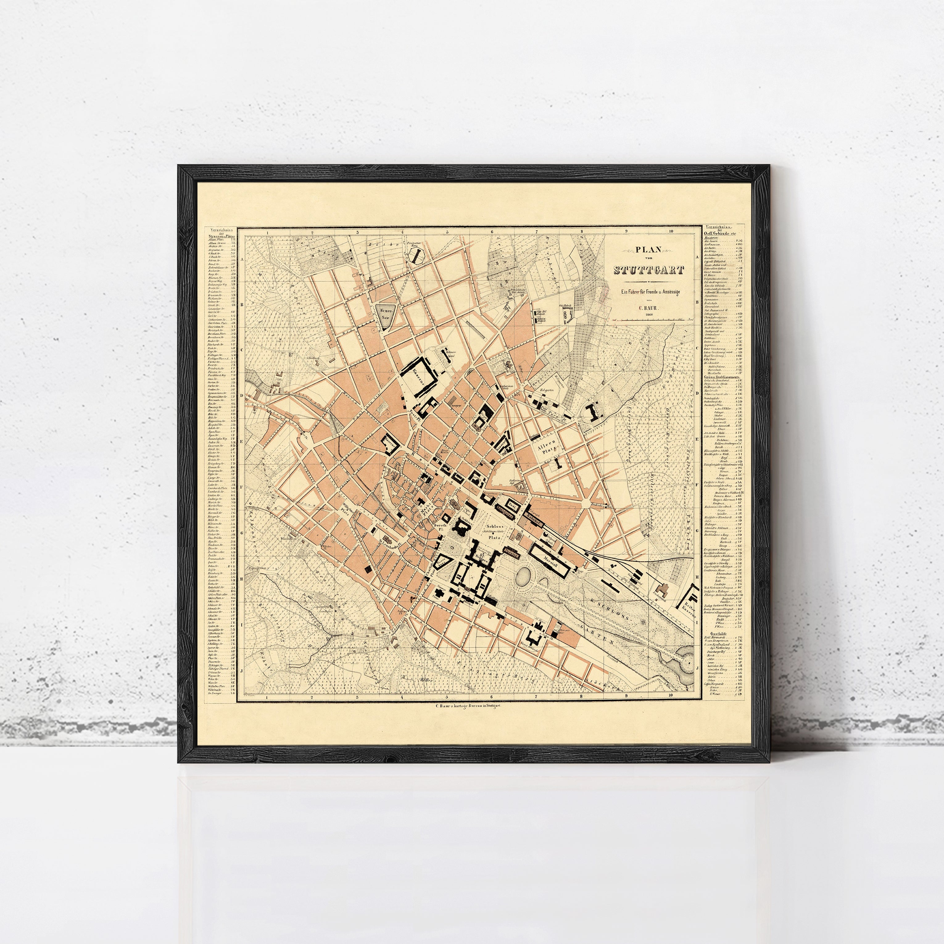 The image is a framed map of a city, likely from the 19th century, depicting a detailed layout of the streets and surrounding areas.