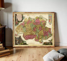 The image is a framed antique map of Europe, featuring detailed illustrations and colorful landmasses.