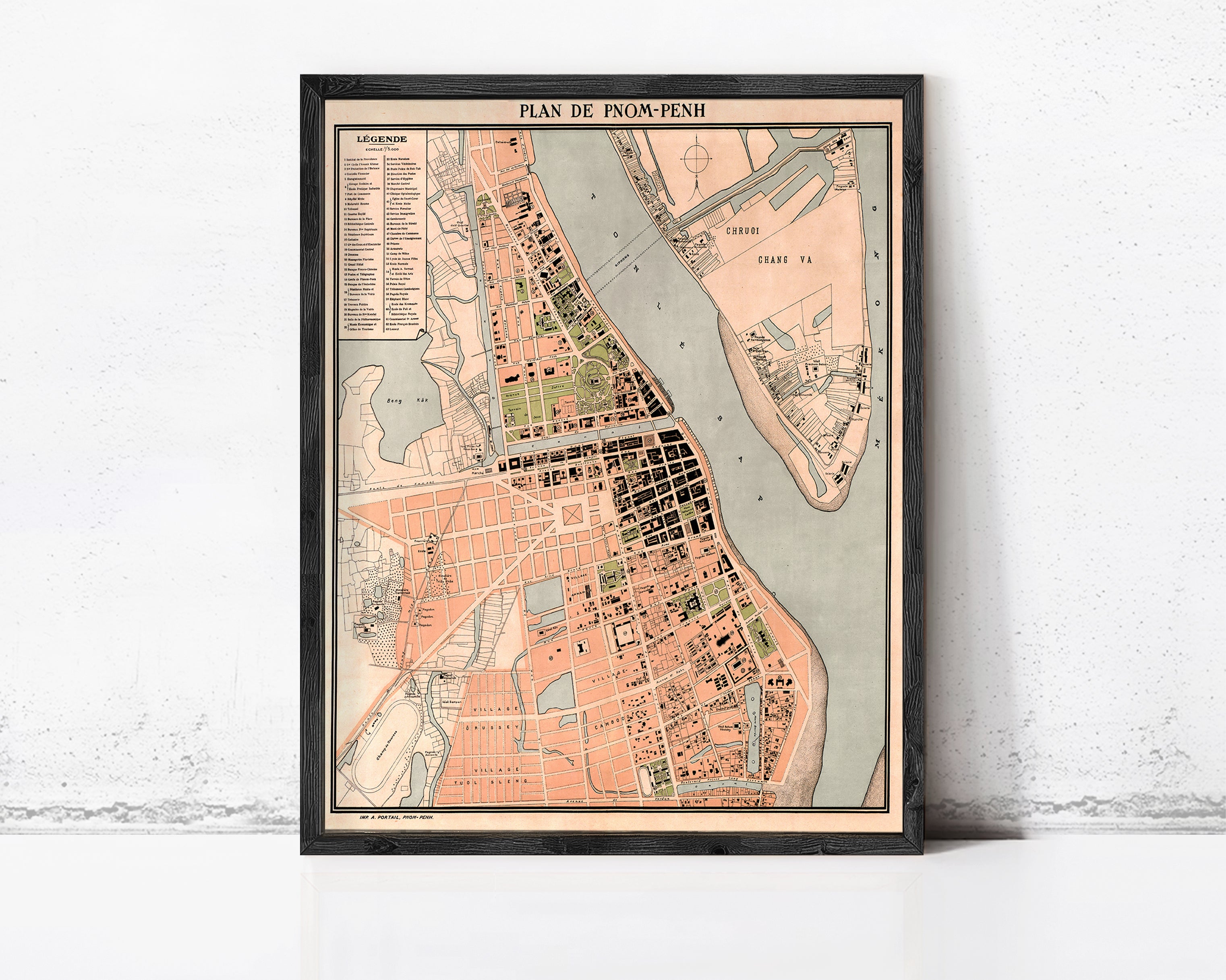 The image is a framed map of a city, likely from the 19th century, depicting a detailed layout of the city's streets, buildings, and other landmarks.