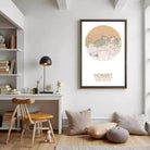 a cozy and well-organized living space with a desk, chair, bookshelf, and a framed map of Hobart, Australia.