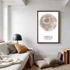 a cozy living room with a white sofa, a lamp, and a framed map of Vienna hanging on the wall.